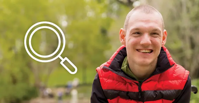 Young man outside in nature smiling