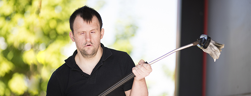 Man holding a car wash broom