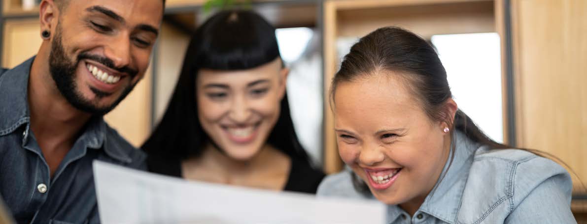 Young girl looking at a document with a colleague