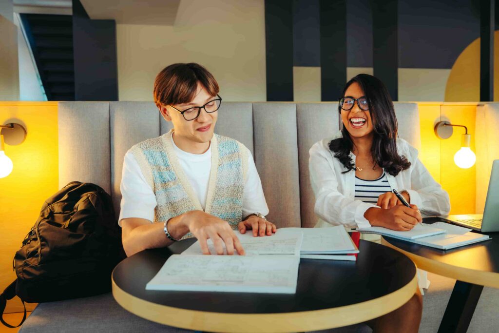 Two young students studying together in library