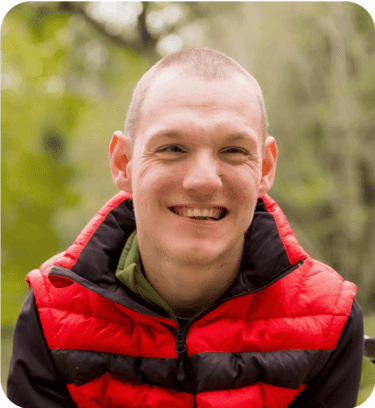 A young man in a wheelchair in a park setting