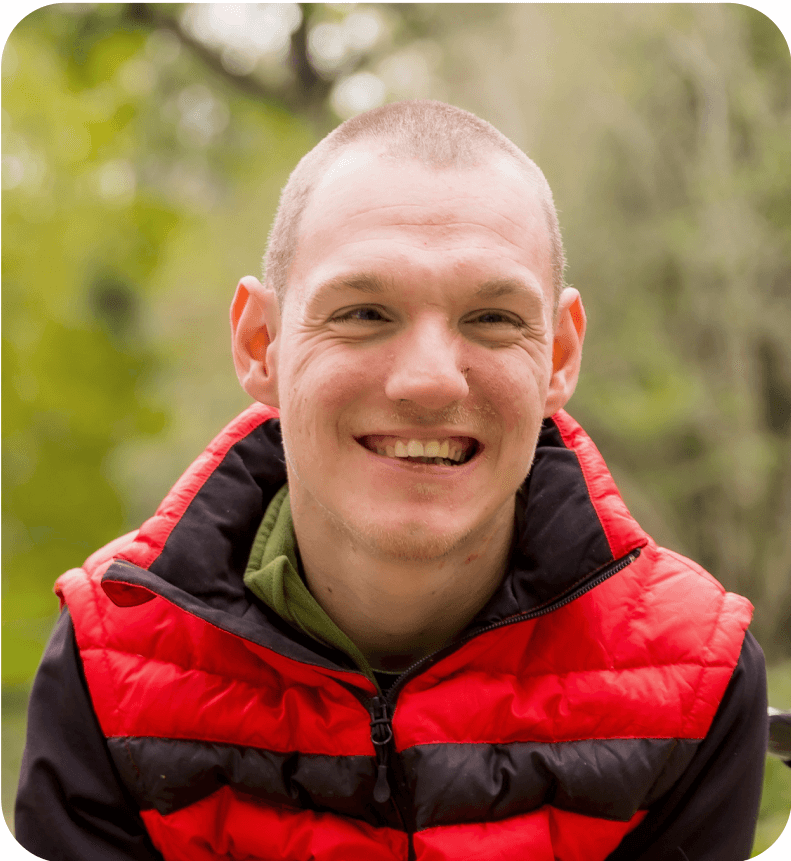 A young man in a wheelchair in a park setting