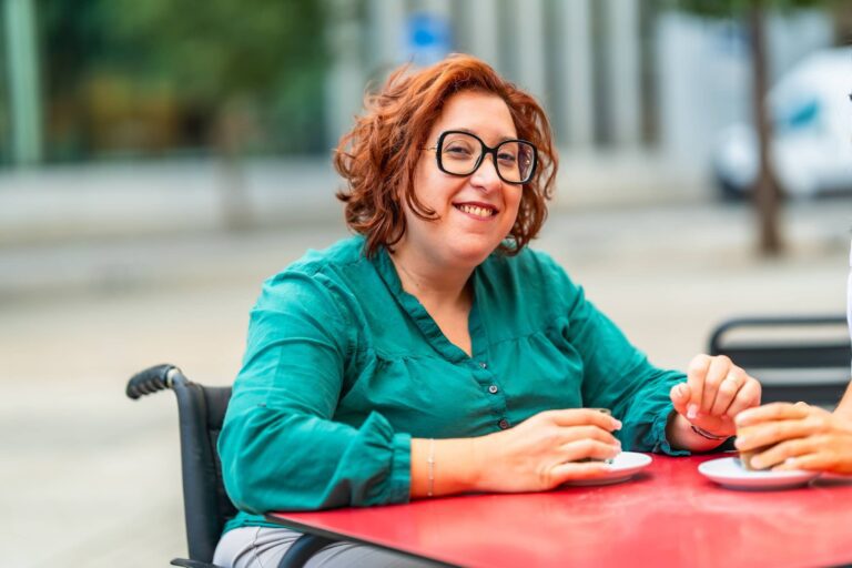 Woman in a wheelchair at a cafe.