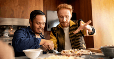 Young man has dinner with his support worker