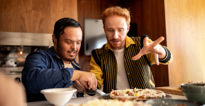 Young man has dinner with his support worker