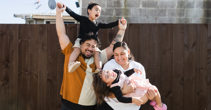 A young family playing together and laughing
