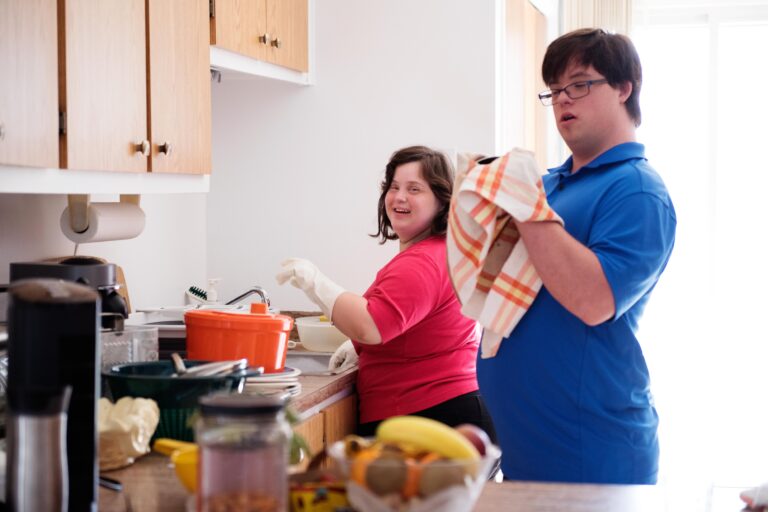 Two young adults doing the dishes
