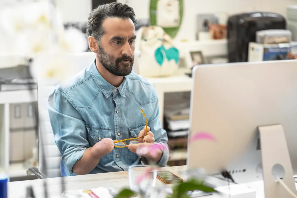 A man sitting at a computer in an office setting