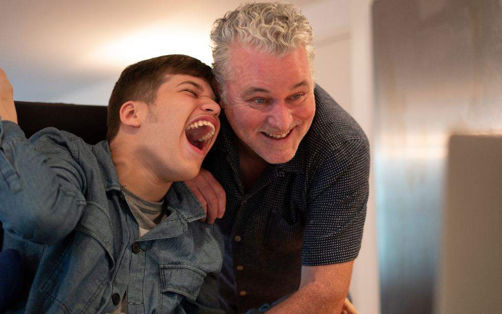 Older man embracing teenage boy