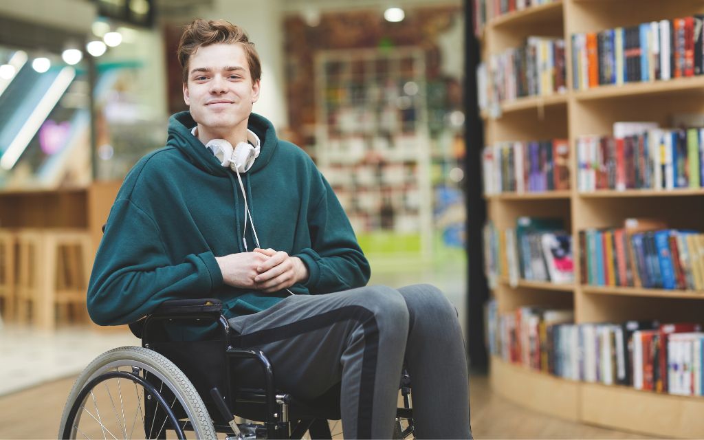 Man in a wheelchair at a bookstore