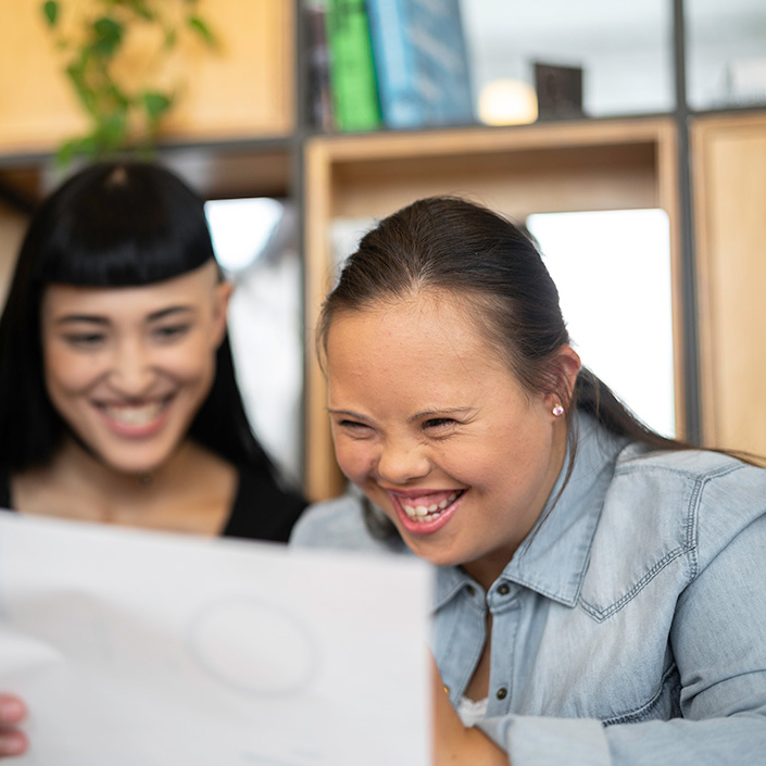 Young girl looking at a document with a colleague