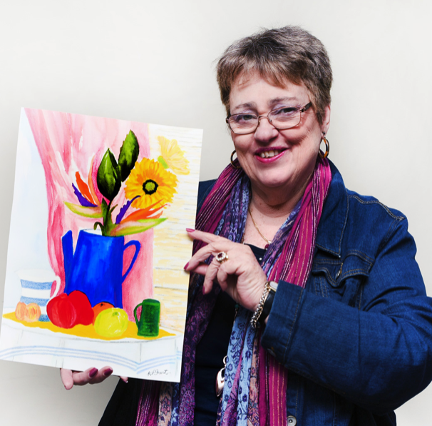 Kerry Frost holding one of her paintings