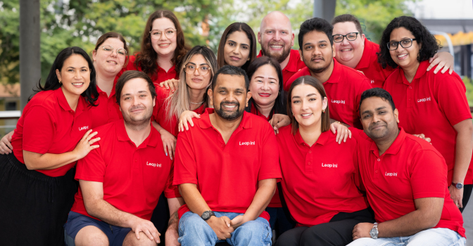 Dr Dinesh and the leap in! crew, smiling in a group hug.