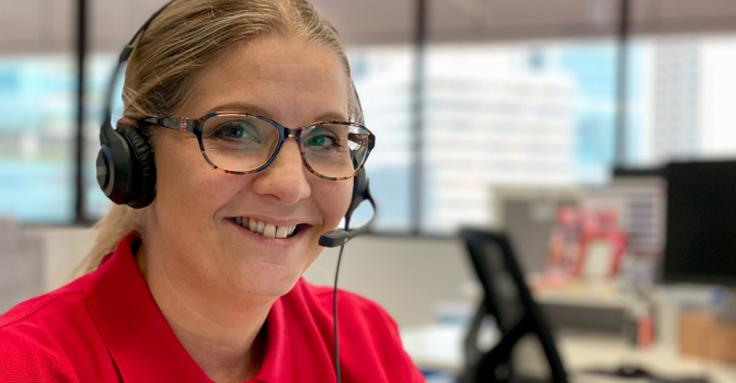 Leap in! Plan manager, Tabitha, at the office with a headset on