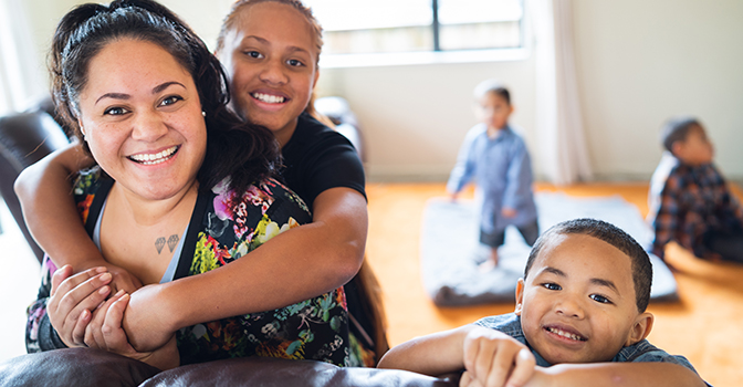 Happy mother with kids at home.