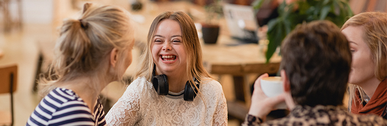 Young woman at a coffee shop with three friends