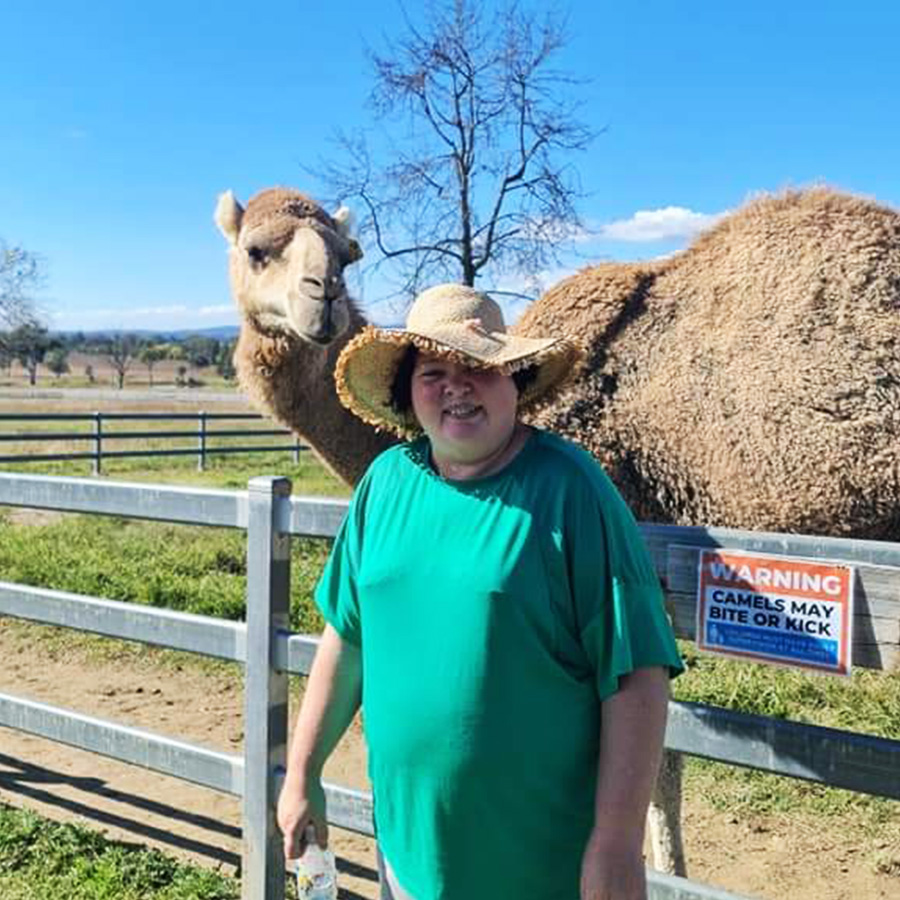 Leap in! member Lisa standing in front of a camel in it